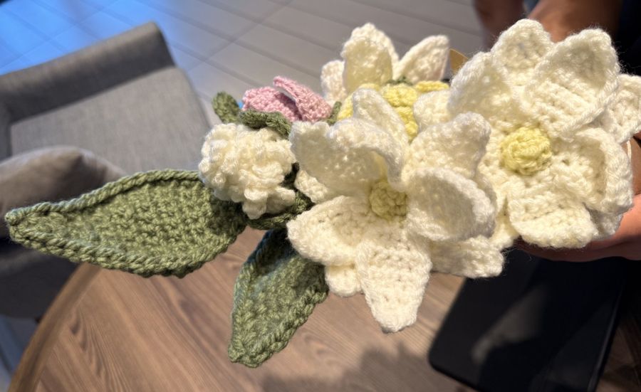 Crocheted blossoms and leaves in cream, pink, and green.
