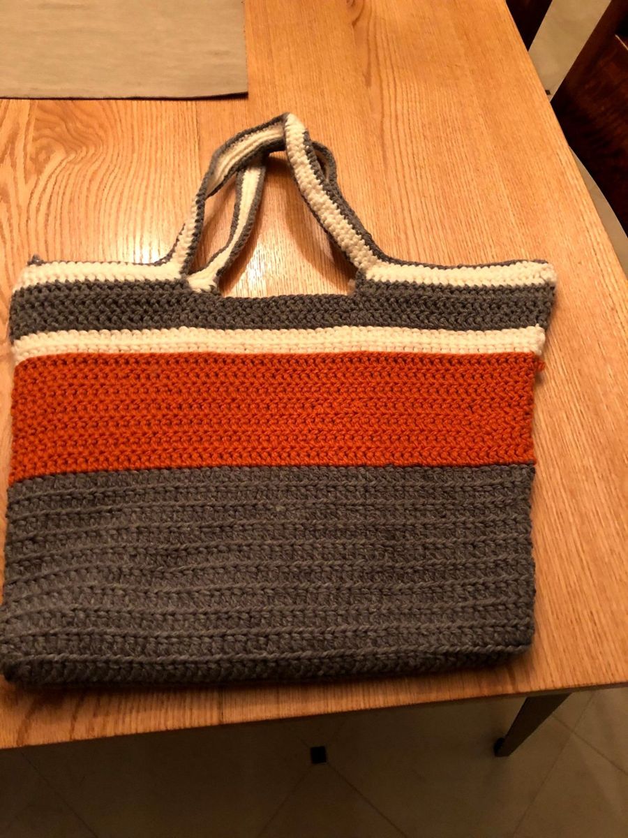 Crocheted tote in gray, cream, and rust.